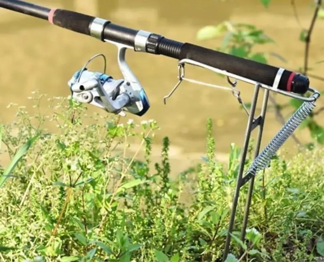 RodPerch automatic spring fishing rod holder staked into a river bank with a loaded rod